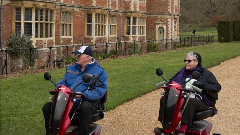 Visitors using PMVs in the garden at Blickling Estate